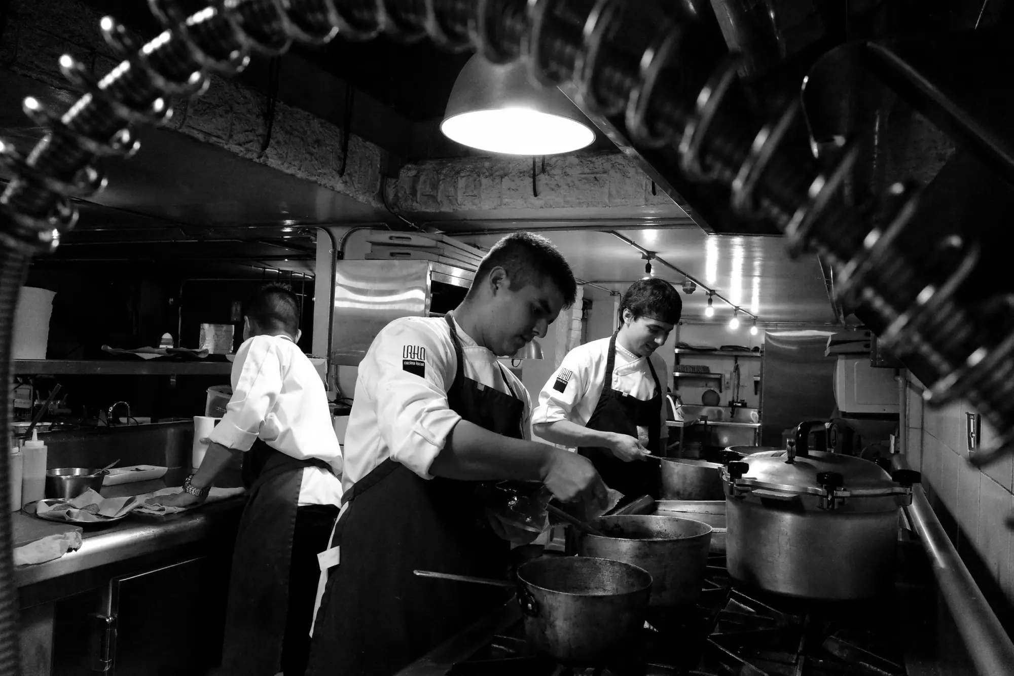 Line cooks working the stove in a restaurant kitchen